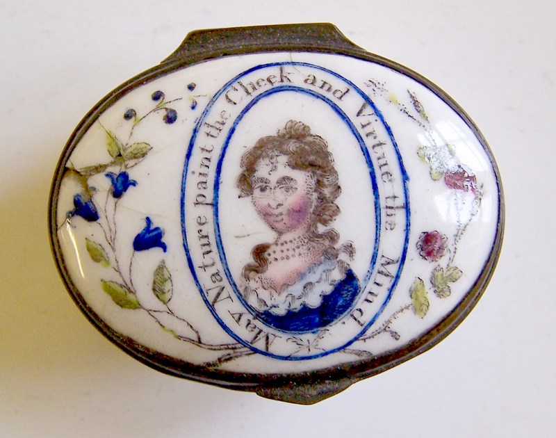 The head and shoulders of a young woman , encircled by the mmotto and pretty floral decoration