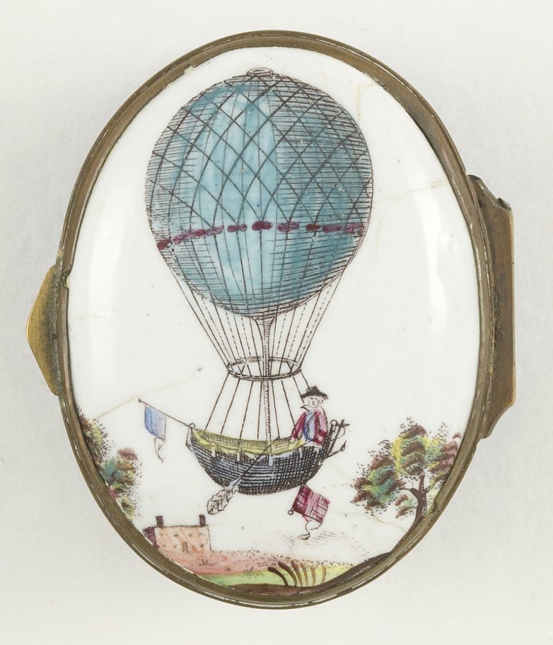 A blue balloon with one man in its basket, flying over a large house and trees